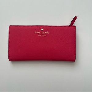 Kate Spade medium size bright pink bifold. Gold zippers and ivory inside.